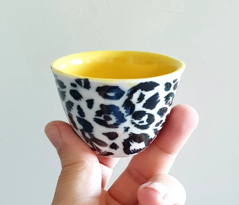 Mugs decorated with underglaze transfers.